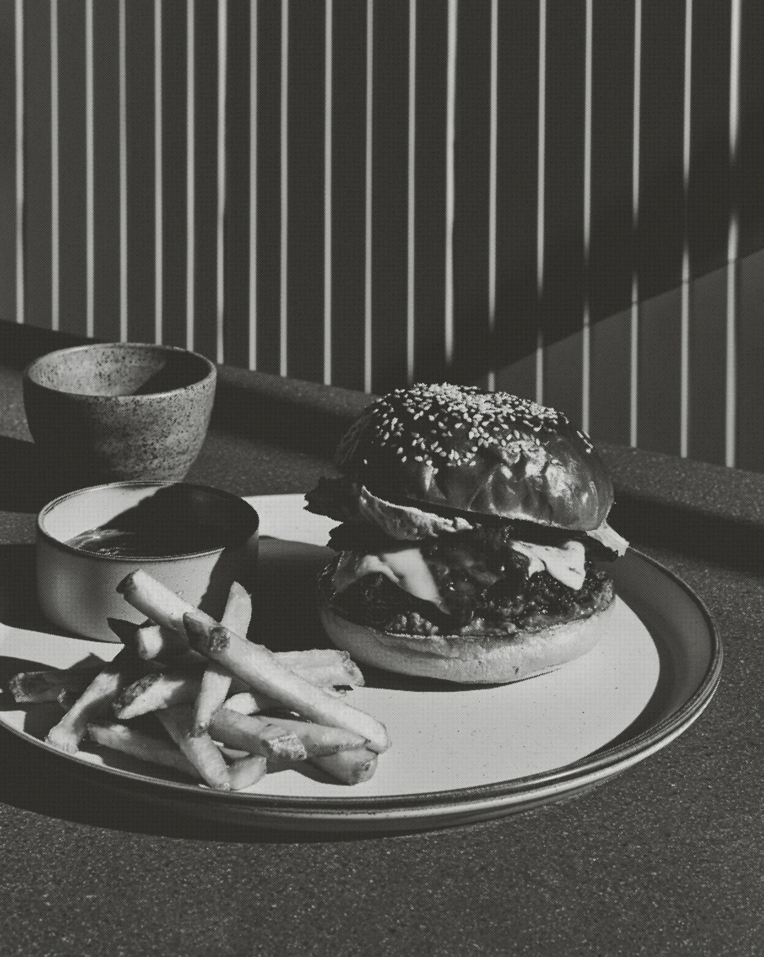Minimal food photography of a delicious burger and fries.