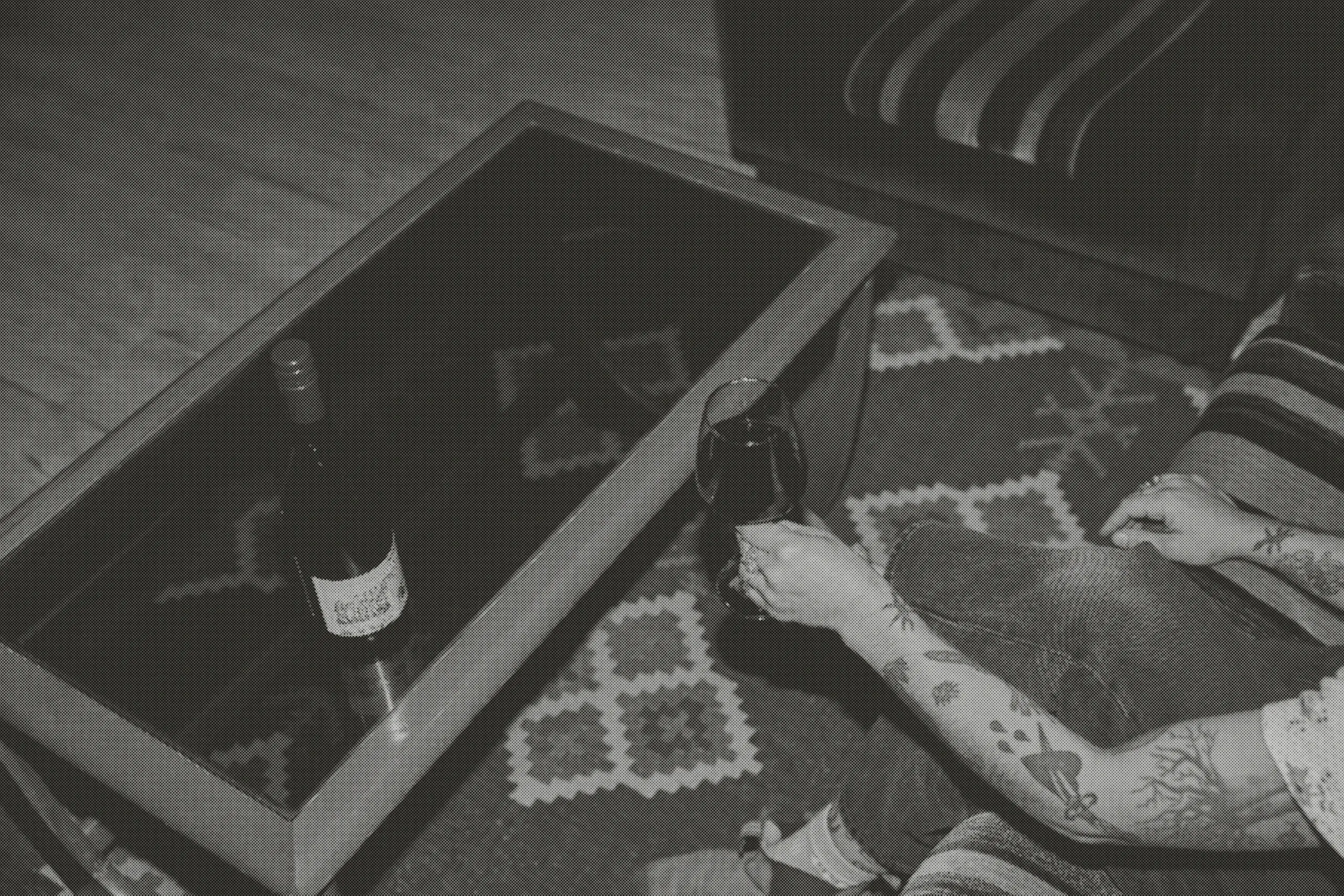 A guest reaching for a glass of red at the lounge coffee table.